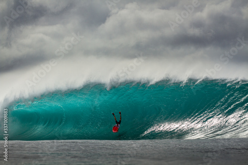 Bodyboarder falling on huge wave