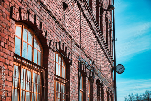 old brick building with windows and an old clock .