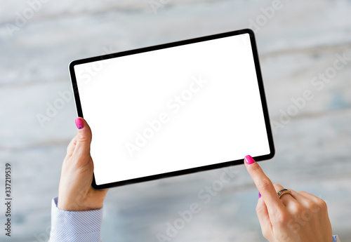 Woman holding tablet with empty white screen