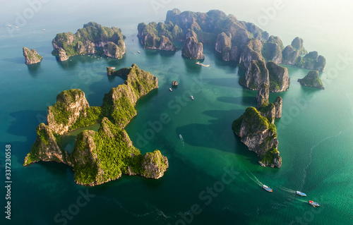 Aerial view floating fishing village and rock island, Halong Bay, Vietnam, Southeast Asia. UNESCO World Heritage Site. Junk boat cruise to Ha Long Bay. Popular landmark, famous destination of Vietnam