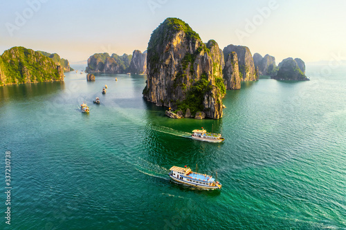 Aerial view floating fishing village and rock island, Halong Bay, Vietnam, Southeast Asia. UNESCO World Heritage Site. Junk boat cruise to Ha Long Bay. Popular landmark, famous destination of Vietnam