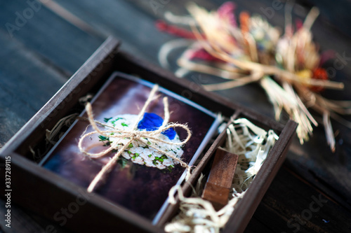 Wedding package for photographers with a wood box with a wood pen drive and pictures