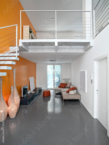 Interiors of a Modern Living Room with Resin Floor and a Staricase