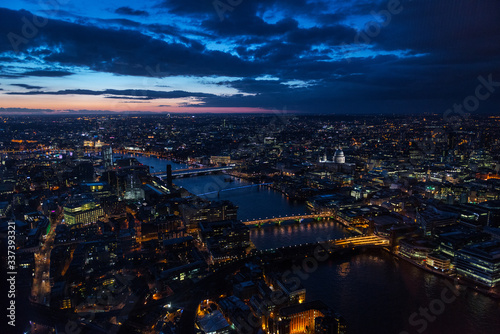 Elevated view of The City of London on a cloudy Spring night. Grained.