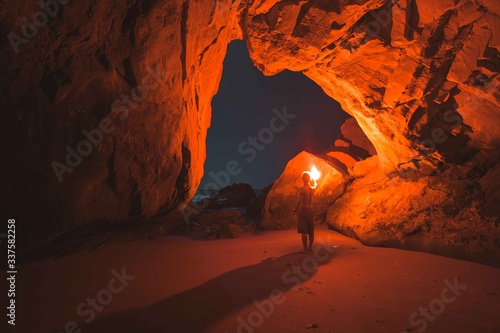 Man with light exploring Antelope Canyon at night
