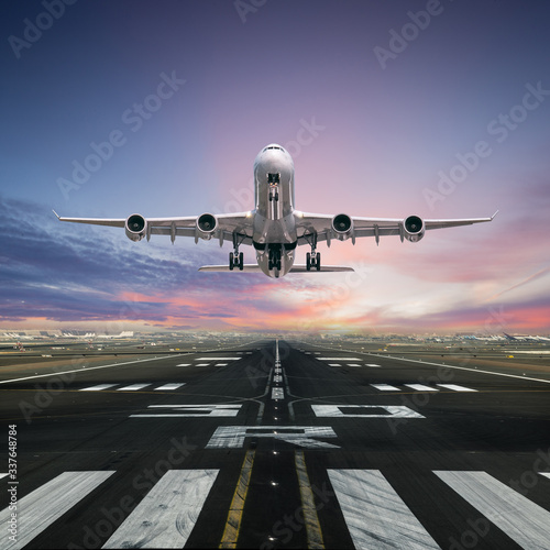 Airplane taking off from the airport runway, front view