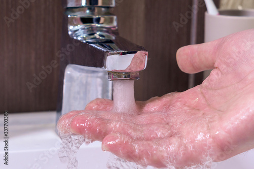 hygiene concept, a man washing hands in the bathroom close-up