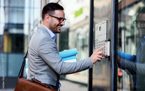 Man pushing the button and talking on the intercom