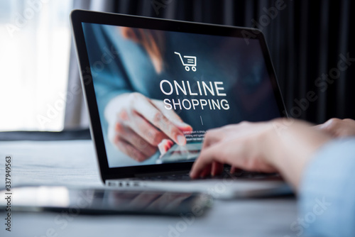 E-commerce and online shopping concept, Woman hand using laptop (Mockup website) and holding credit card for shopping payment online at home.