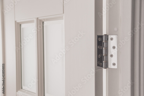stainless door mortised hinge on a white door
