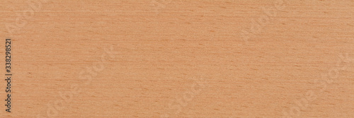 Natural beech veneer background in warm beige color. Natural wood texture, pattern of a long veneer sheet, plank.