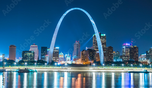 st. louis skyscraper at night with reflection in river,st. louis,missouri,usa.