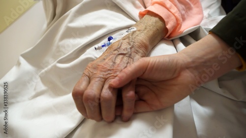 Deathbed old age care of grandmother bedridden with a cannula, close up shot