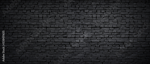 Texture of a black painted brick wall as a background or wallpaper