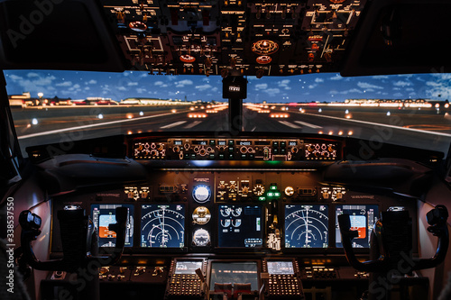 Dramatic Full view of cockpit modern Boeing aircraft before take-off. Airplane is ready to fly. Night shot in cabin. Safety flight