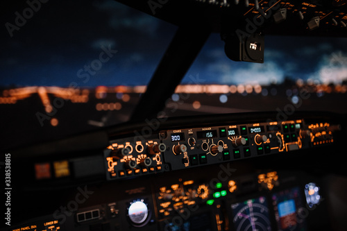 Autopilot controller. Display navigator system of Boeing aircraft. Automatic landing system. Night shot inside cabin. ILS