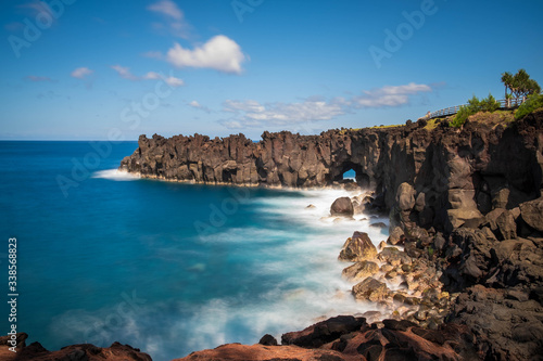 Reunion island seascape, landscape Black sand, volcanic rocks, Waves breaking at the Coast