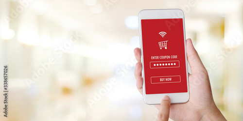 E-coupon, Shopping online, Hand using mobile phone with discount coupon on screen, online shopping sale on smartphone, digital marketing, retail business and technology, e commerce promotion concept