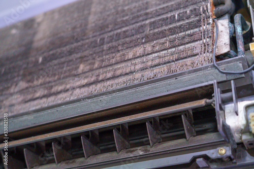 Old air conditioner and focus evaporator of dirty, foul, be putrid Before cleaning on the purple wall in the home office in the summer and circuit board control.