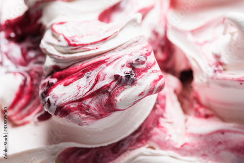 Cherry flavour gelato - full frame detail. Close up of a white surface texture of Cherry Ice cream covered with red stripes