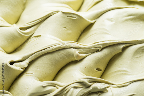 Pistachio flavour gelato - full frame detail. Close up of a creamy green surface texture of Pistachio Ice cream