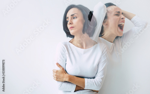 Schizophrenia. Close-up photo of a young beautiful sad woman suffering from multiple personality disorders. Double exposure.