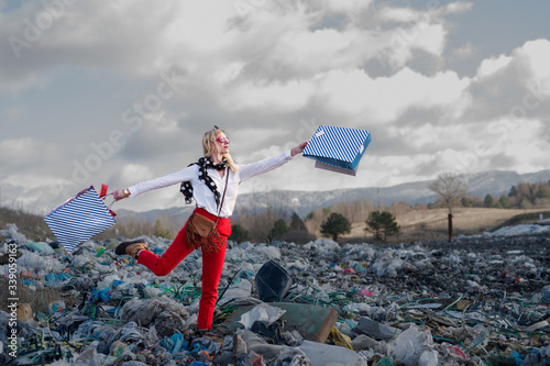 Modern woman on landfill, consumerism versus pollution concept.