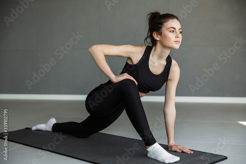 Photo of athletic beautiful woman doing exercise while working out