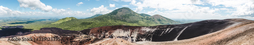 Panoramic view over a volcanic crater and lush green mountains around Cerro Negro, an active volcano near Leon, Nicaragua