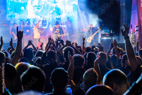 Fans at live rock music concert cheering