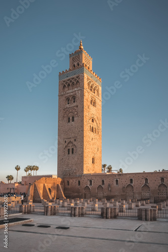 Koutoubia Mosque minaret during twilight located at medina quarter of Marrakesh, Morocco, North Africa. Sunset view on a sunny day with blue sky.