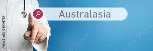 Australasia. Doctor in smock points with his finger to a search box. The term Australasia is in focus. Symbol for illness, health, medicine