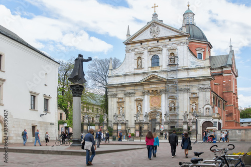 St. Peter and Paul Church with statues of saints on the Grodka Street in the Old Town of Krakow. A memorial of Jesuit priest Piotr Skargaon the St. Mary Magdalene Square.