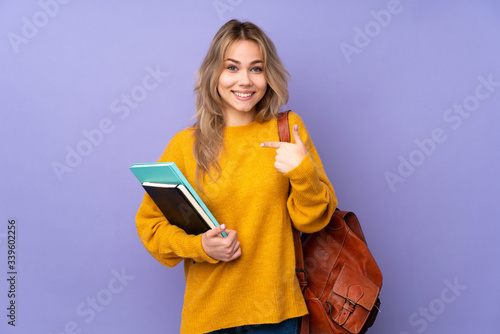 Teenager Russian student girl isolated on purple background with surprise facial expression
