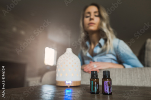 Young woman smelling her essential oil diffuser