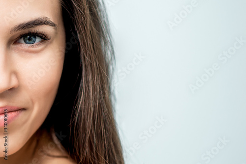 Half face of woman close-up isolated on white background with copy space.