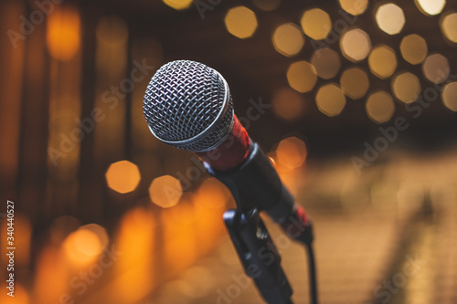 Concert Backstage - Microphone On The Theater Stage Before The Show With Empty Seats And Blurred Lights