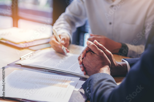 businessman reading documents at meeting, business partner considering contract terms before signing checking legal contract law conditions