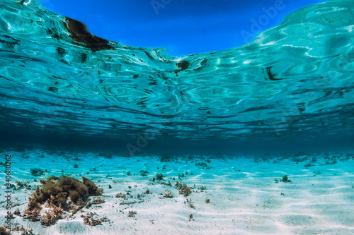 Turquoise ocean with sandy bottom underwater. Tropical sea in paradise island