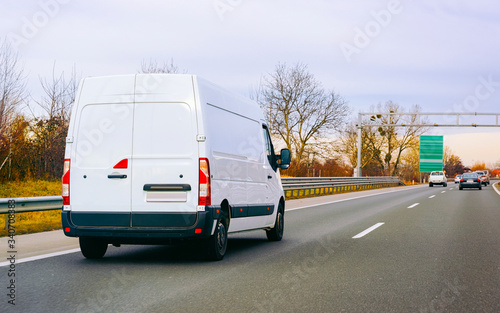 White Minivan on road on driveway van transport reflex