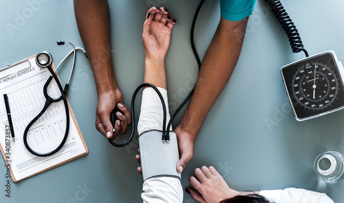 Nurse measuring patient blood pressure