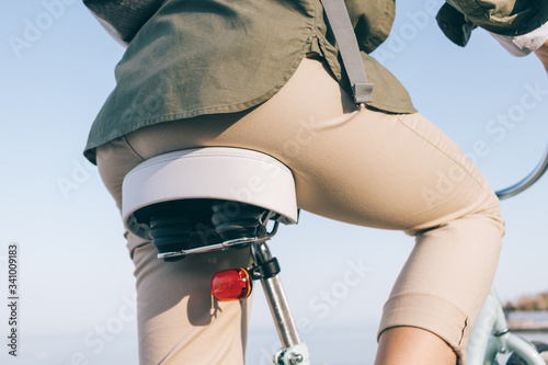 Rear view of young woman wearing casual beige trousers