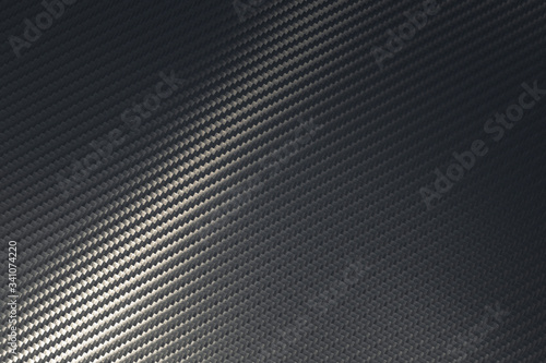 Bended surface of grey woven carbon fibre composite sheet.