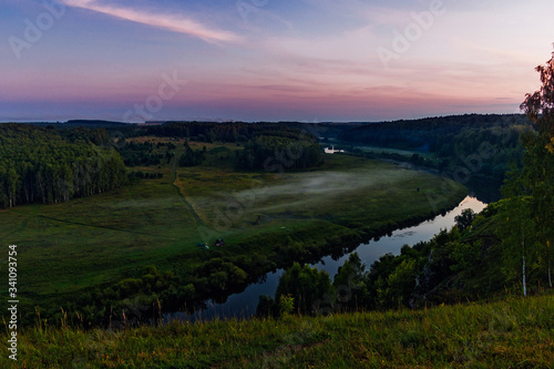 river and forest from a high hill at sunset