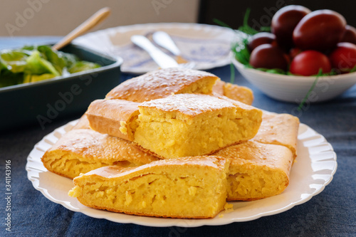 Close up view on cornbread corn pone in a white plate on the table covered with sesame seed organic vegetarian food vegan