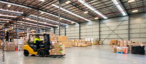 Forklift working at logistics warehouse