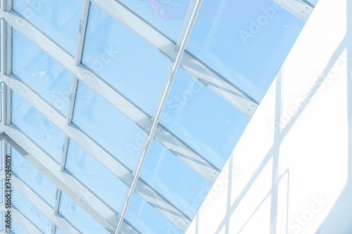 Clean roof windows and blue sky. Element of a modern glass roof of a shopping mall or airport, abstract image