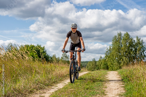 A man on a bicycle.