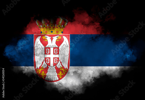 Serbia flag performed from color smoke on the black background. Abstract symbol.