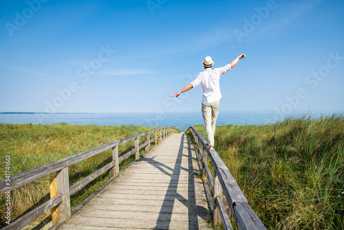 Young man enjoying his freedom near the beach